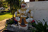 Luang Prabang, Laos. Wat Aham, door guardian statues of the sim. 